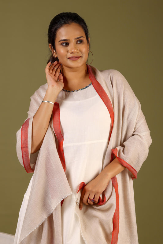 Woman wearing a beige and red traditional