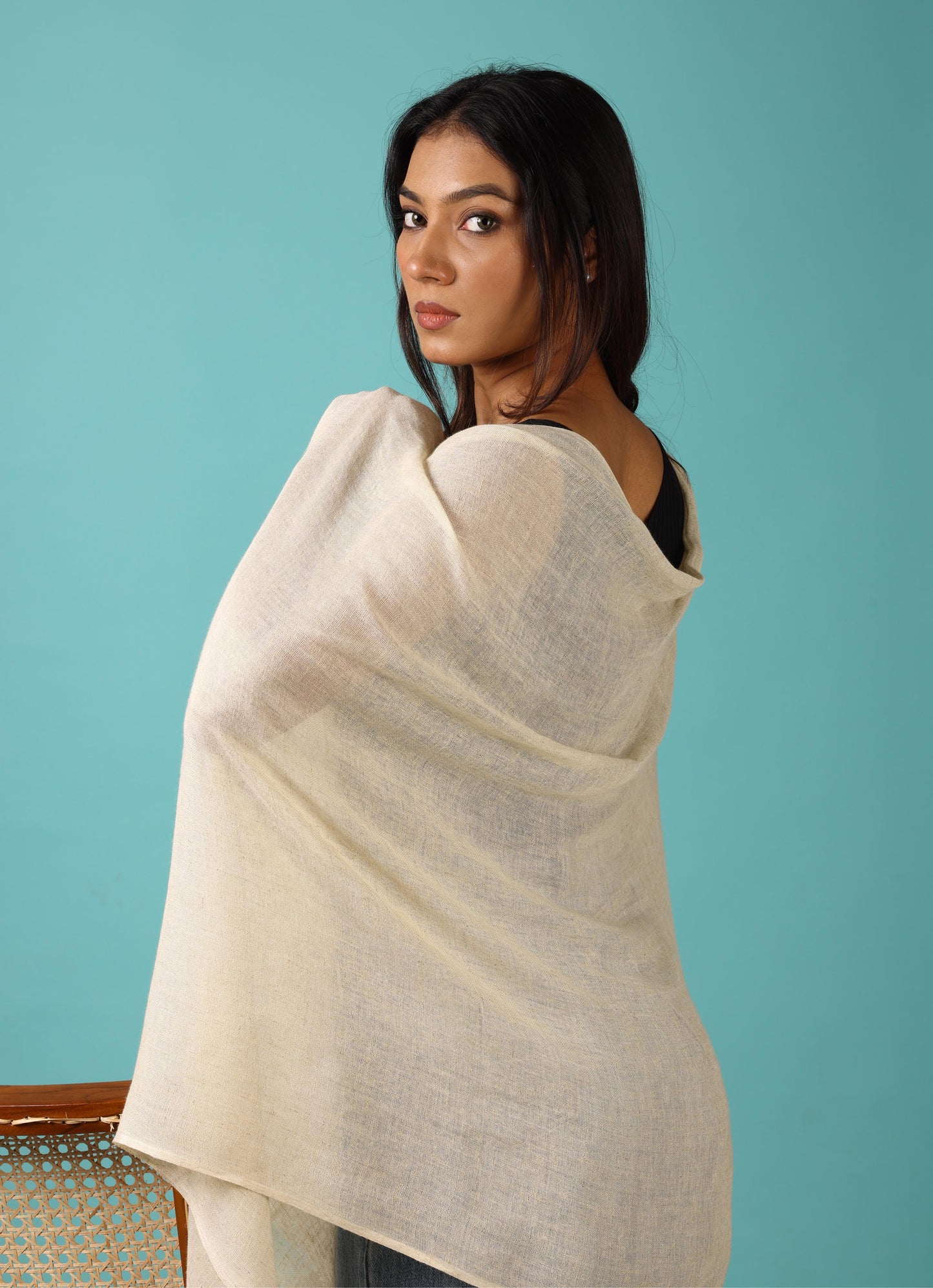 Woman wrapped in a beige blanket