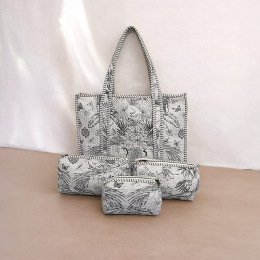 Set of three bags with floral pattern on a beige surface