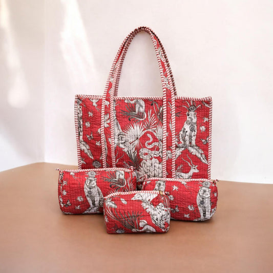Set of red patterned handbags on a beige surface with a white background