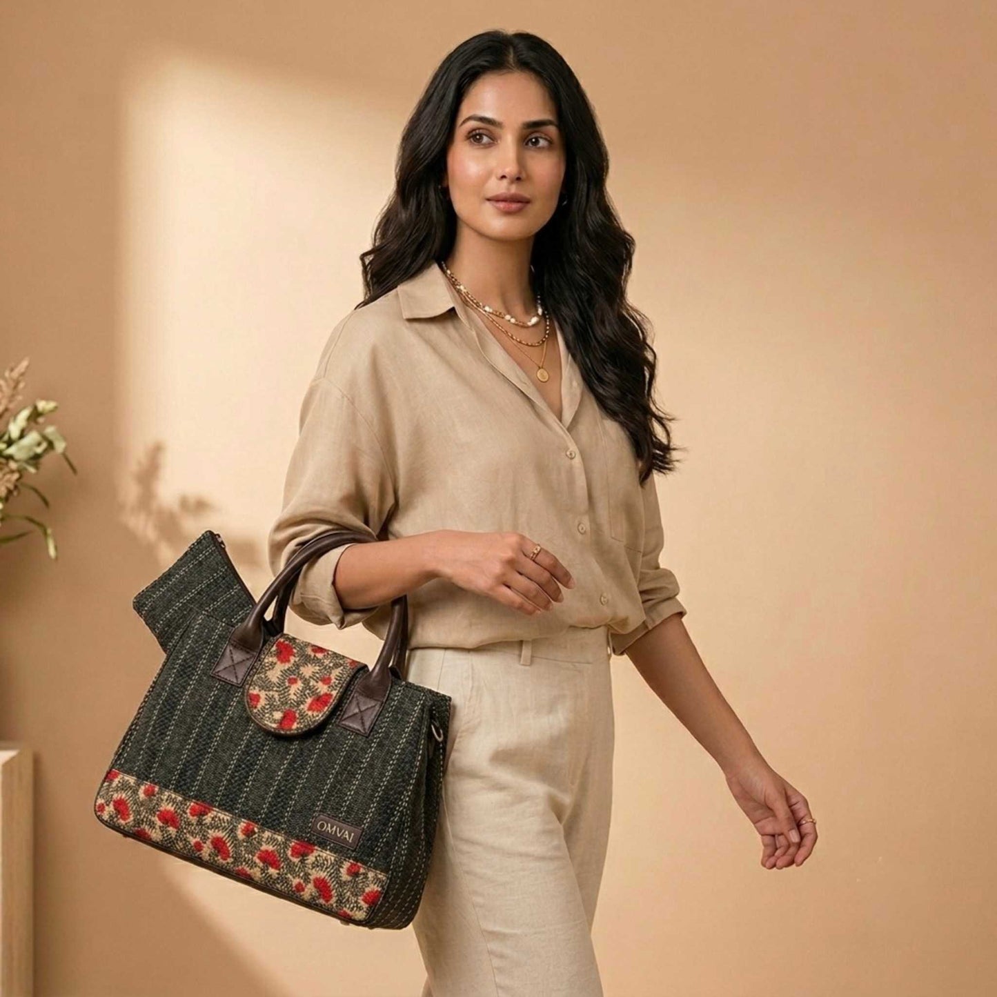 Woman holding a floral-patterned handbag against a beige background