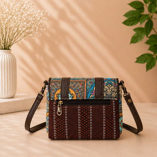 Multicolored patterned handbag on a wooden surface with a neutral background
