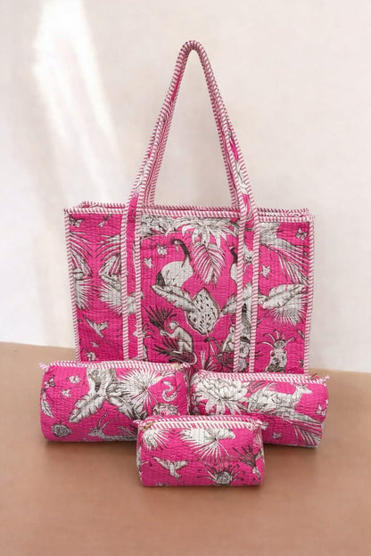 Set of pink bags with white floral patterns on a beige surface