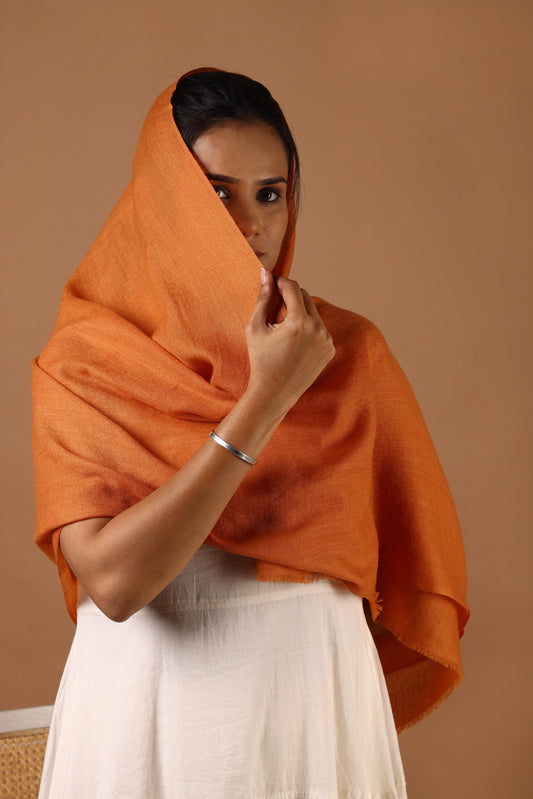 Woman wearing an orange shawl 