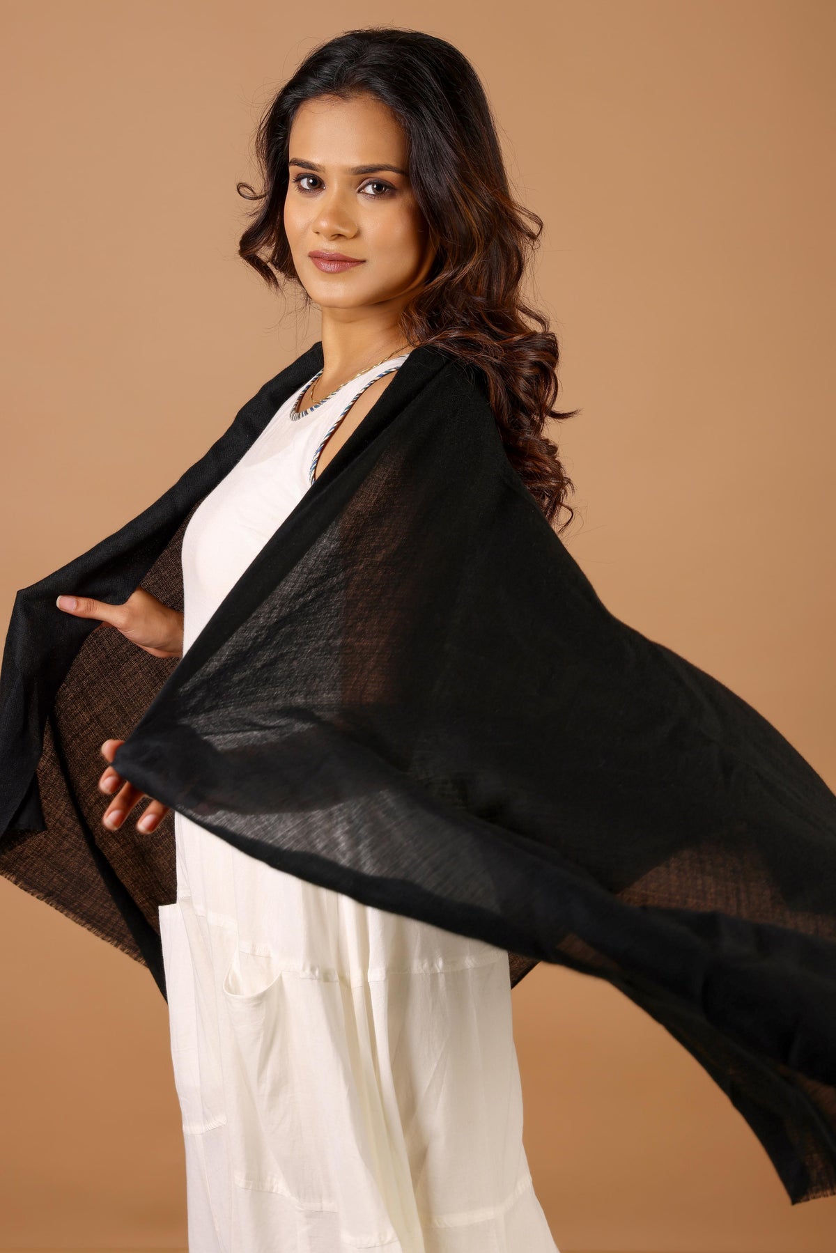 Woman holding a black scarf
