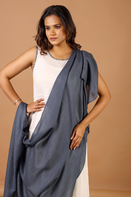 Woman wearing a blue draped garment