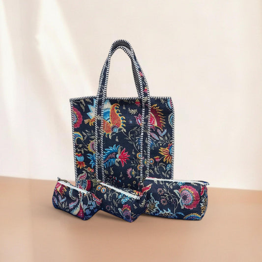 Floral patterned tote bag with matching pouches on a beige surface