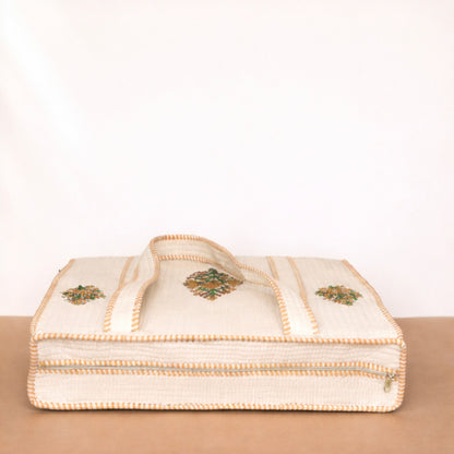 Beige fabric with embroidered patterns on a beige surface