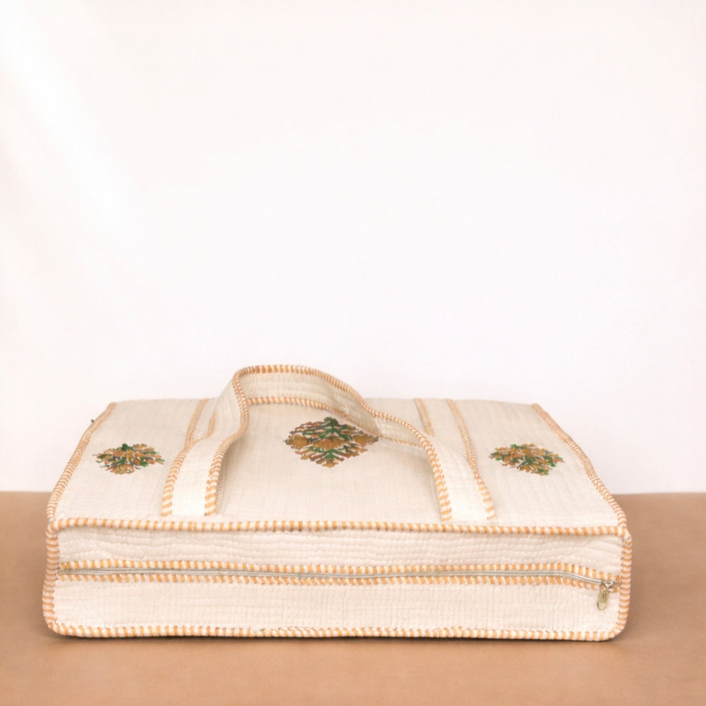 Beige fabric with embroidered patterns on a beige surface