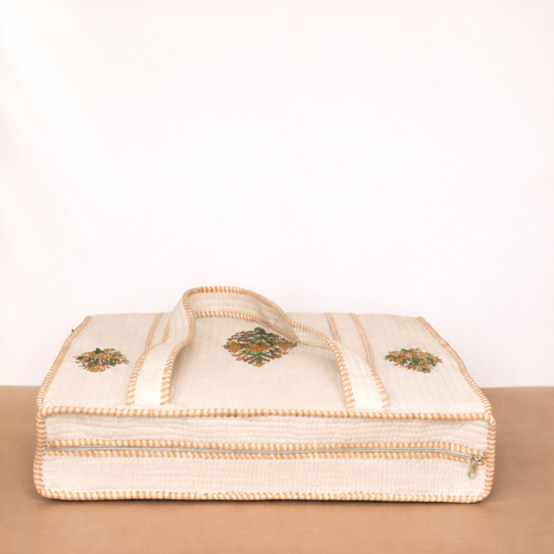 Beige fabric with embroidered patterns on a beige surface