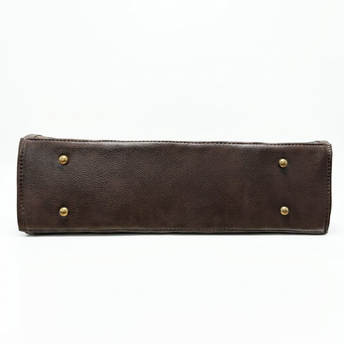 A dark brown textured leather clutch or wallet shown from the bottom edge, featuring four brass-tone rivets on the front face, set against a plain white background.