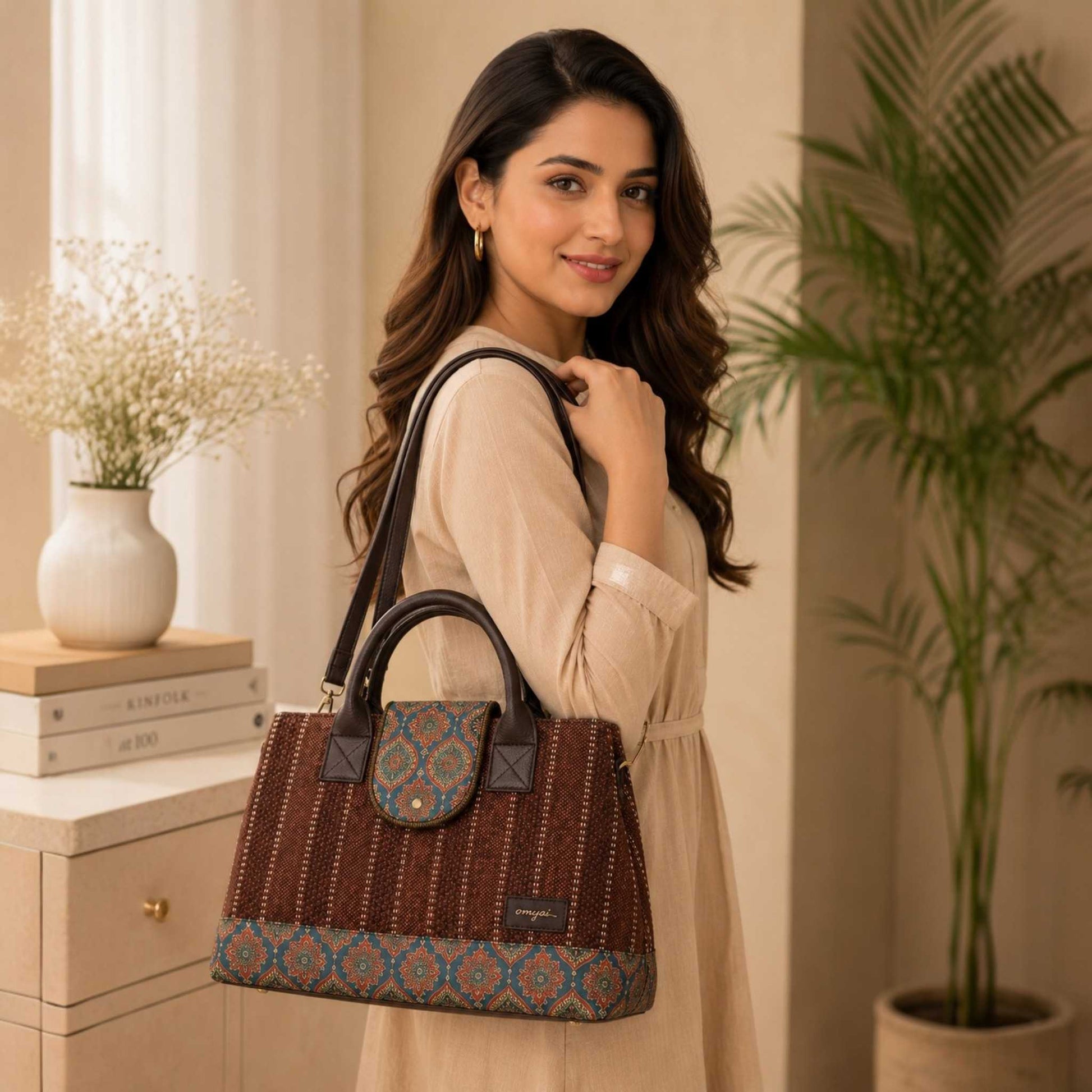 Woman holding a patterned handbag in a home setting