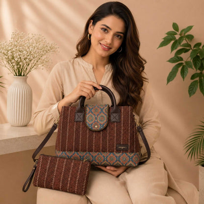 Woman holding a woven handbag with a patterned top section, sitting against a beige background.