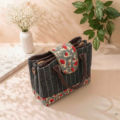 Handbag with floral pattern on a surface with plants in the background