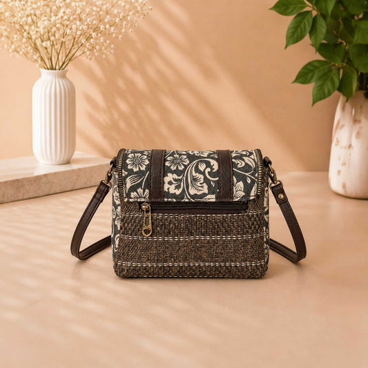Woven handbag with floral pattern on a beige surface with decorative elements.