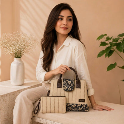 Woman holding a handbag with floral design in a home setting