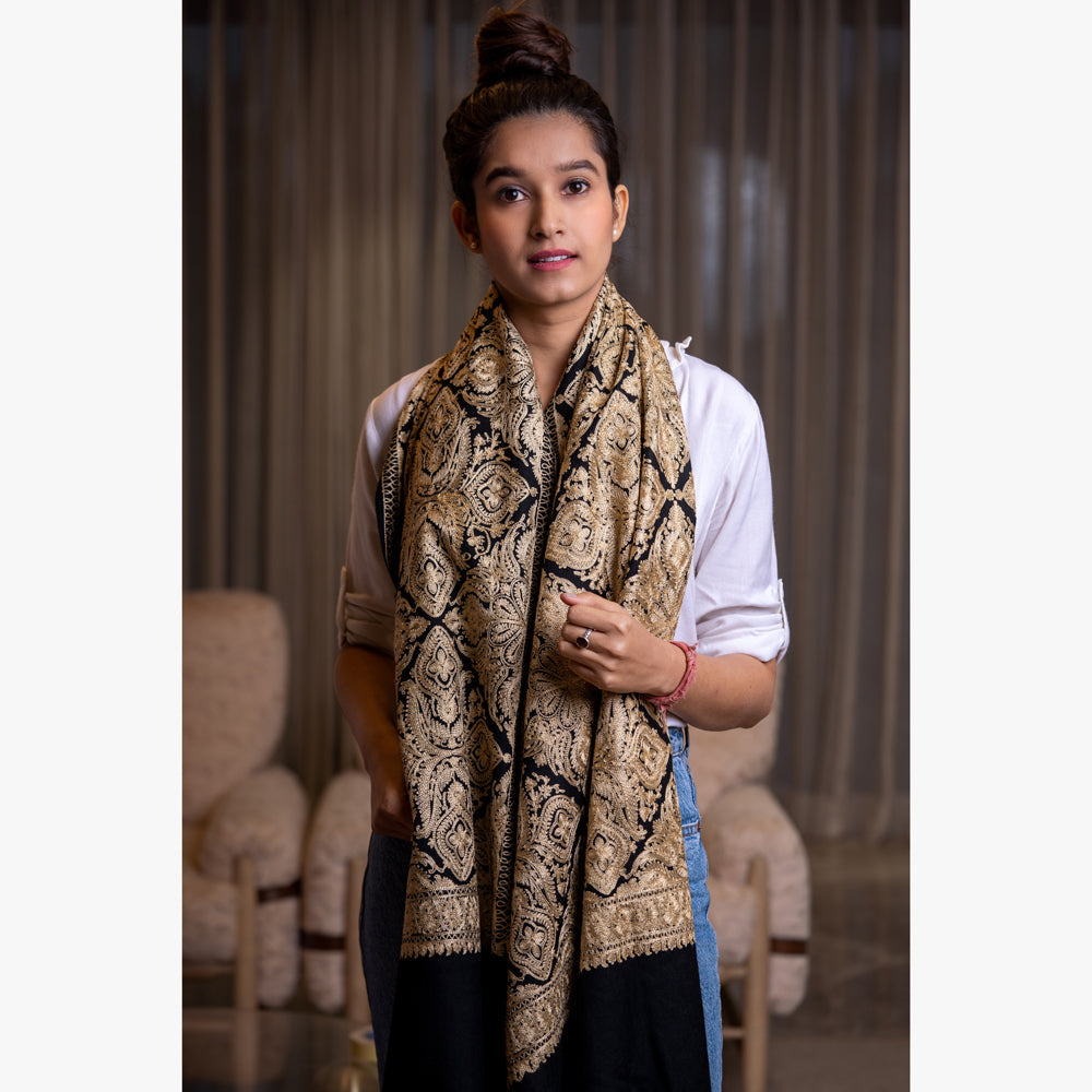 woman draping a black embroidered shawl